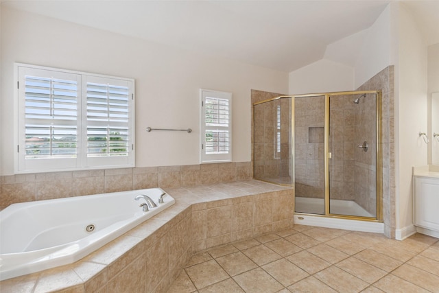 bathroom featuring separate shower and tub, a wealth of natural light, and tile patterned flooring