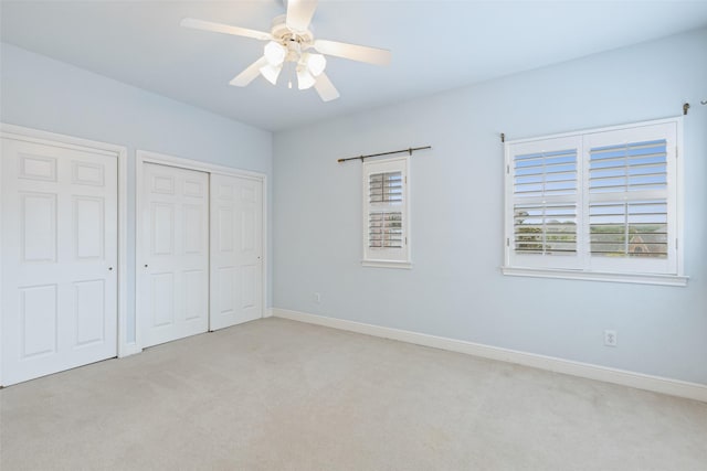 unfurnished bedroom with light colored carpet and ceiling fan