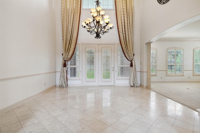 interior space featuring an inviting chandelier and crown molding