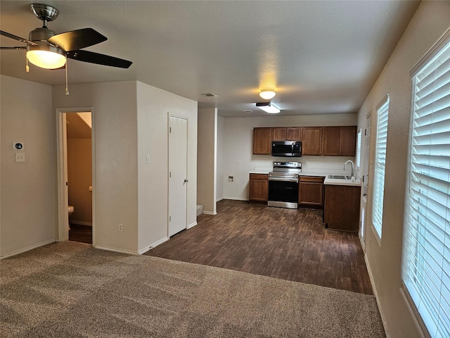 kitchen featuring dark hardwood / wood-style floors, ceiling fan, sink, and appliances with stainless steel finishes