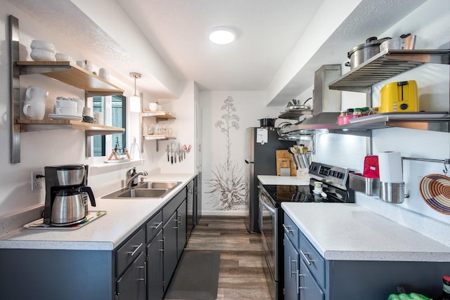 kitchen with blue cabinetry, sink, dark hardwood / wood-style floors, decorative light fixtures, and stainless steel range with electric stovetop