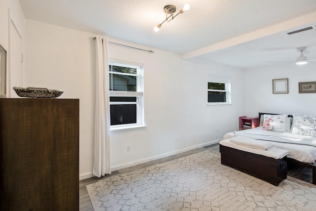 bedroom with a textured ceiling and light hardwood / wood-style flooring