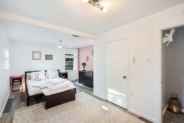 bedroom featuring wood-type flooring and a textured ceiling