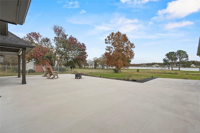 view of yard with a water view and a patio