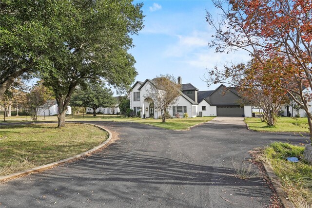 view of front facade featuring a front lawn and a garage