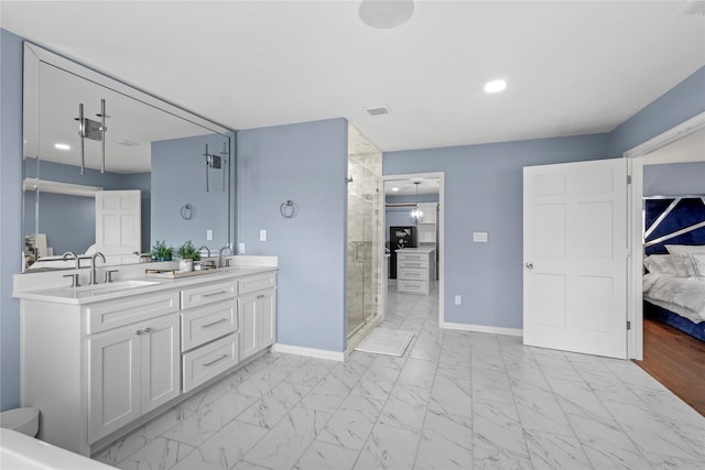 bathroom featuring vanity and a shower with shower door