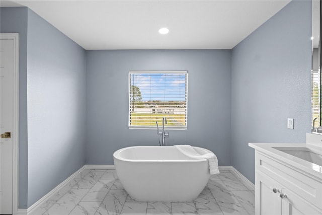 bathroom featuring vanity and a tub