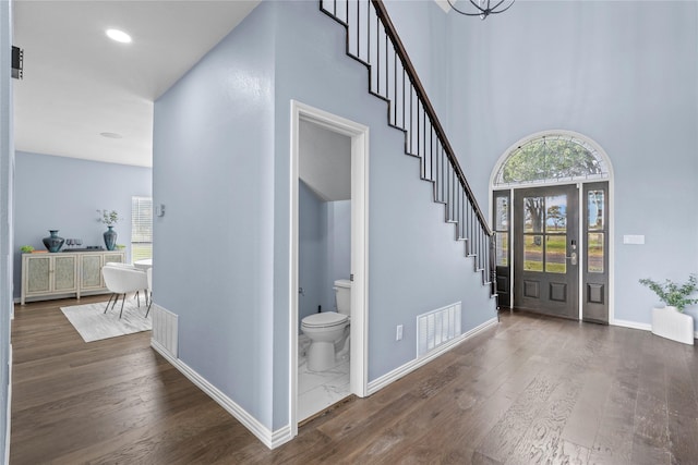 entryway featuring a high ceiling and dark wood-type flooring