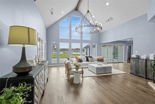 living room with french doors, beamed ceiling, high vaulted ceiling, a notable chandelier, and hardwood / wood-style floors