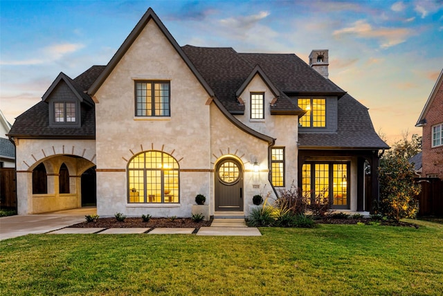 view of front of house featuring french doors and a yard