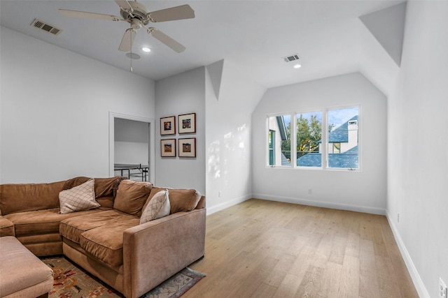 living room with ceiling fan, light hardwood / wood-style floors, and lofted ceiling