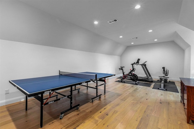 recreation room with light hardwood / wood-style flooring and vaulted ceiling