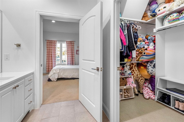 spacious closet with light carpet