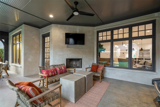 view of patio / terrace featuring an outdoor living space with a fireplace and ceiling fan