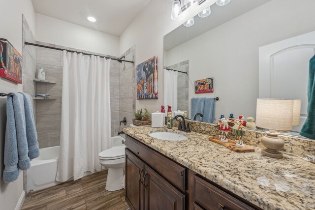 full bathroom featuring toilet, vanity, hardwood / wood-style flooring, and shower / tub combo with curtain