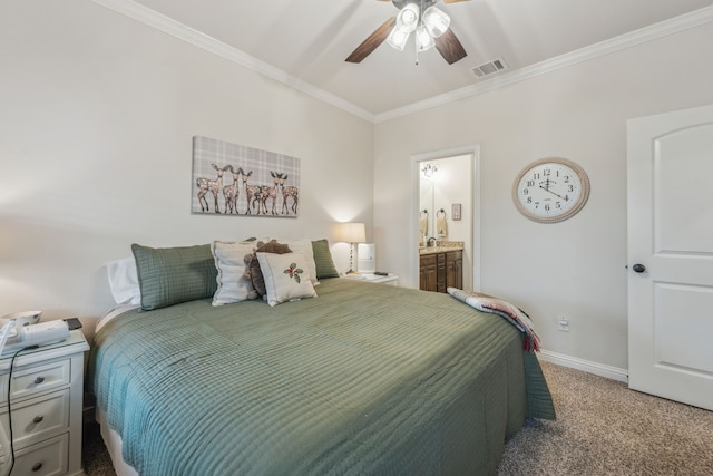 carpeted bedroom featuring ensuite bath, ceiling fan, and ornamental molding