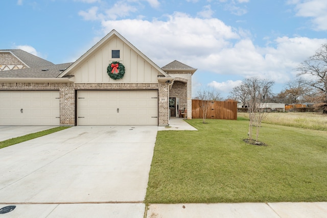 view of front of home with a front yard and a garage