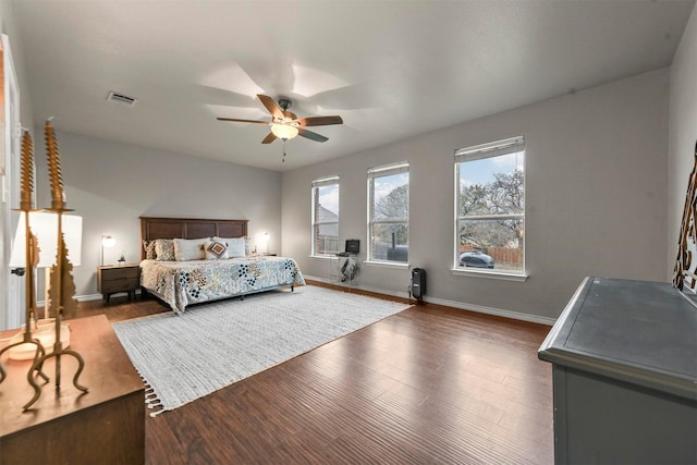 bedroom with a ceiling fan, baseboards, visible vents, and dark wood-style flooring