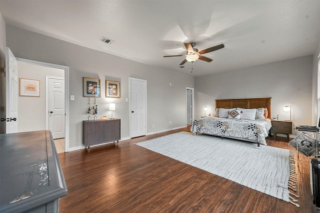 bedroom with baseboards, visible vents, ceiling fan, and dark wood-type flooring