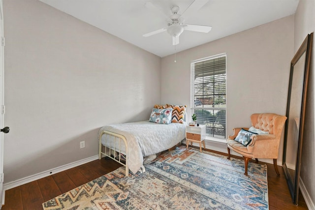 bedroom with a ceiling fan, baseboards, and dark wood-style flooring