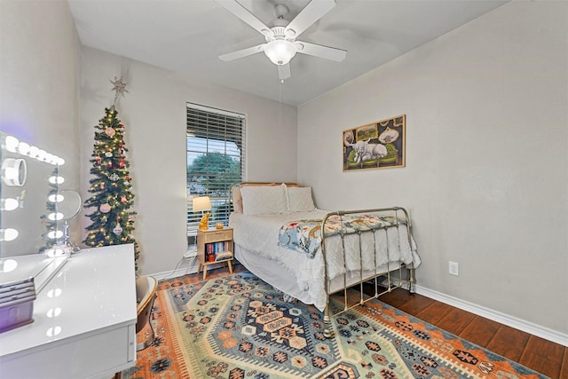 bedroom featuring a ceiling fan, dark wood finished floors, and baseboards