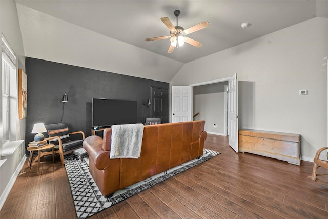 living room featuring baseboards, a ceiling fan, vaulted ceiling, and dark wood-style flooring