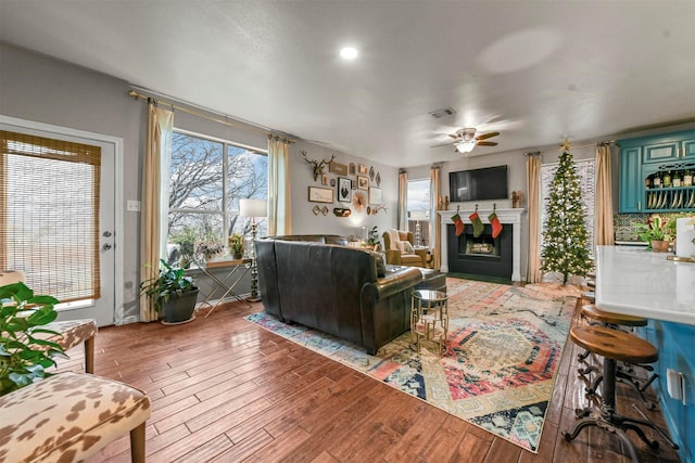 living room with ceiling fan and light hardwood / wood-style flooring