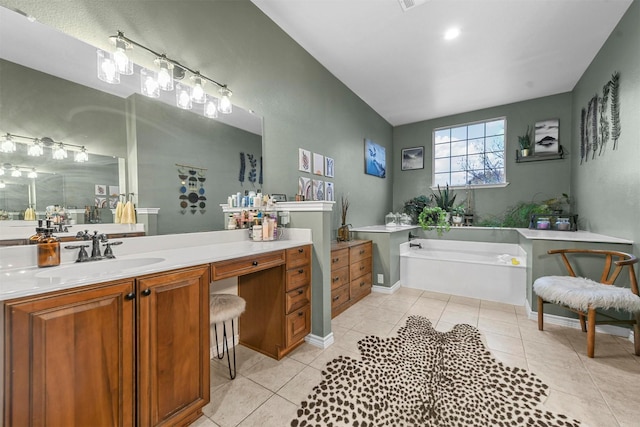 bathroom featuring tile patterned flooring, a garden tub, and vanity