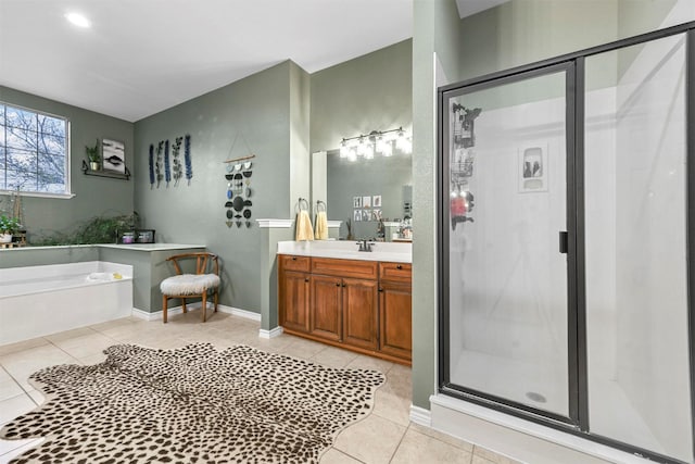 bathroom featuring a garden tub, a shower stall, vanity, and tile patterned floors