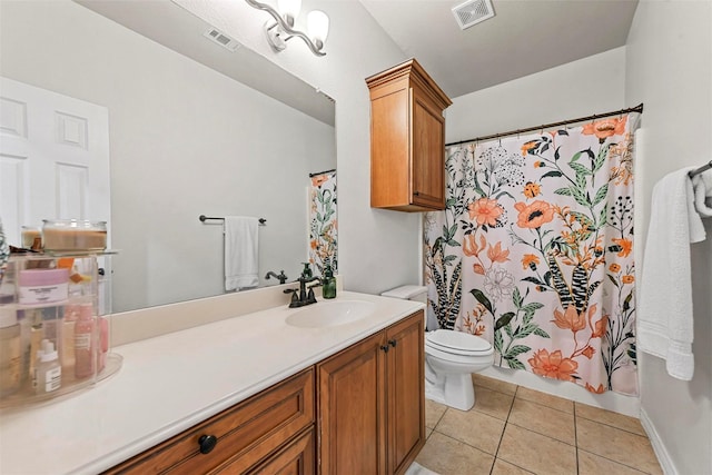 bathroom featuring toilet, vanity, visible vents, and tile patterned floors