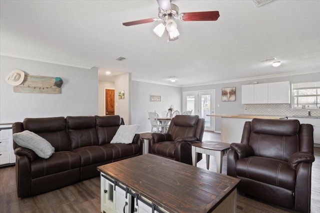 living room featuring ornamental molding, dark hardwood / wood-style floors, and ceiling fan