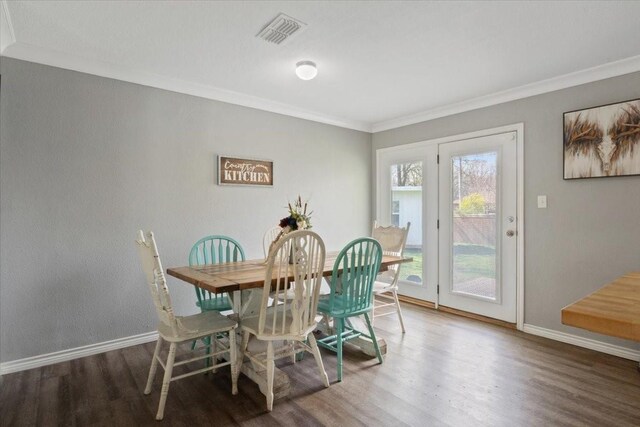 dining room featuring crown molding and hardwood / wood-style flooring