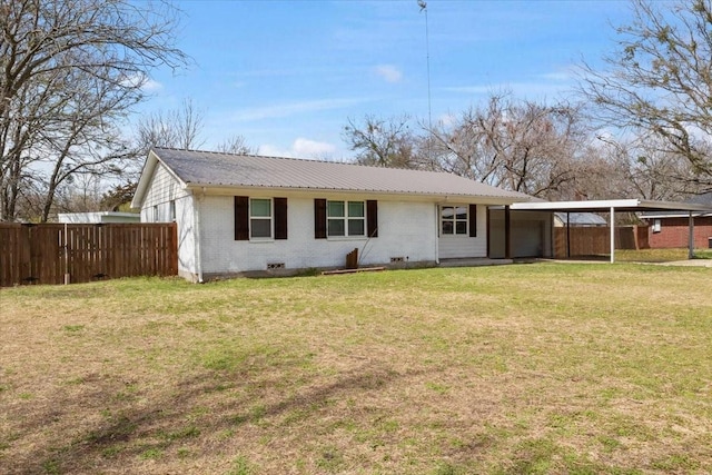 back of house featuring a carport and a yard