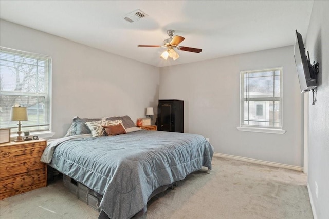 bedroom featuring light carpet and ceiling fan