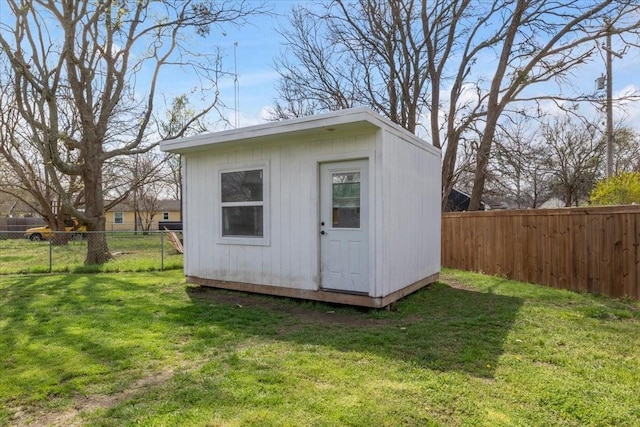 view of outbuilding featuring a lawn