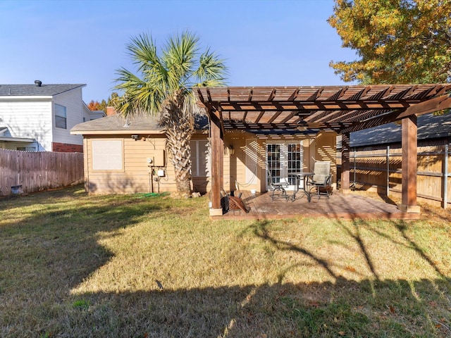 back of property with a lawn, a patio area, and a pergola