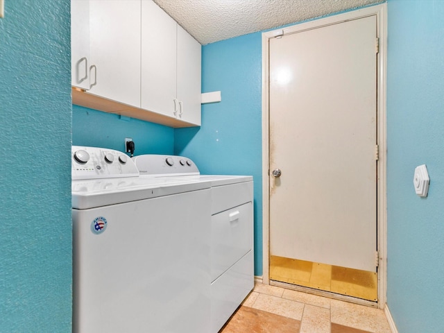 washroom with cabinets, separate washer and dryer, and a textured ceiling