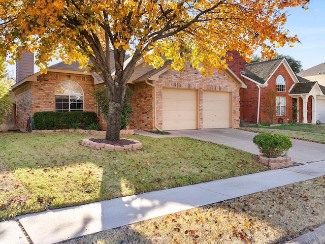 view of front of property featuring a garage and a front lawn