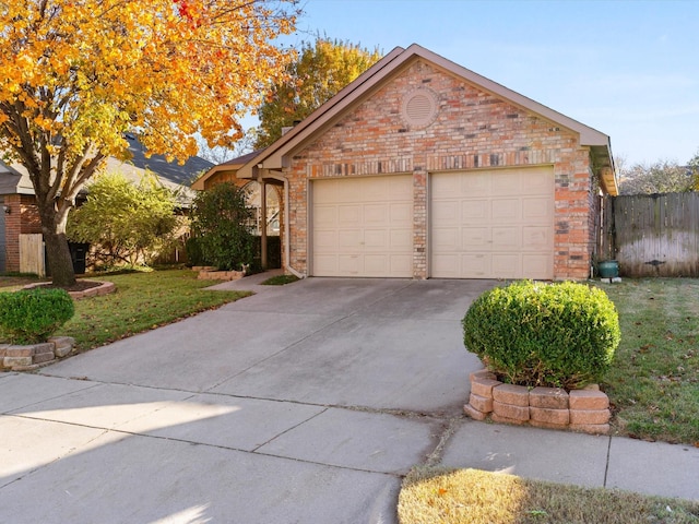 view of front of property with a front yard and a garage