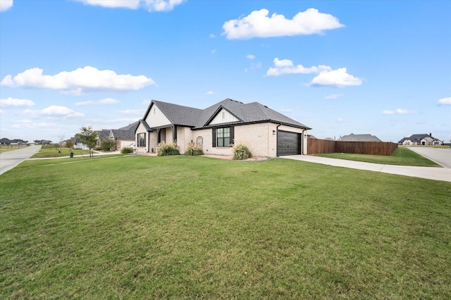 view of front of house featuring a garage and a front lawn