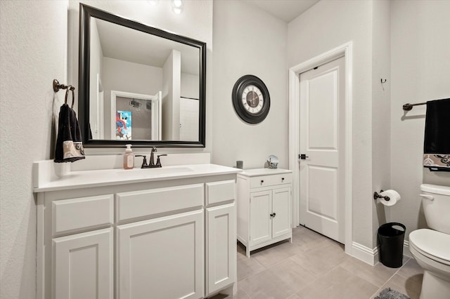 bathroom with tile patterned floors, vanity, and toilet