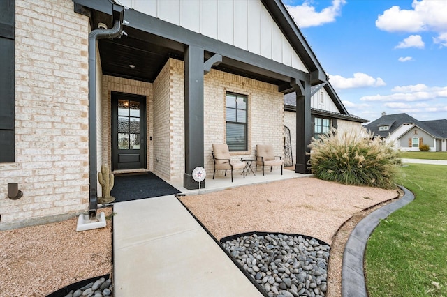 view of exterior entry featuring covered porch