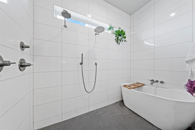 353 Willow Moon Ranch Rd, Crawford, TX 76638 - bathroom featuring tiled shower, a freestanding tub, and tile walls