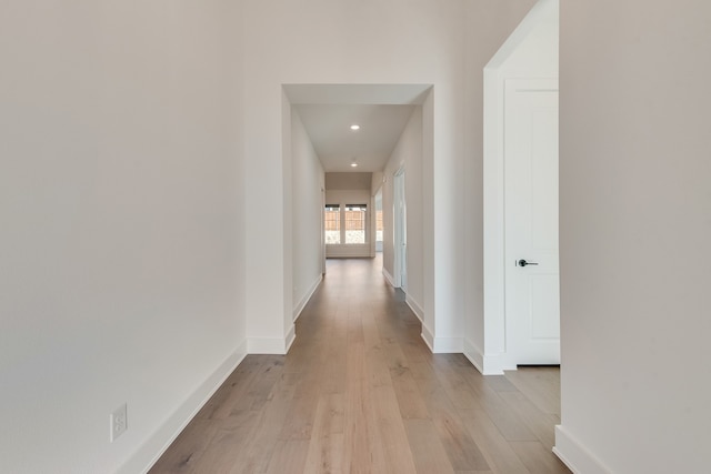 hallway with light hardwood / wood-style flooring