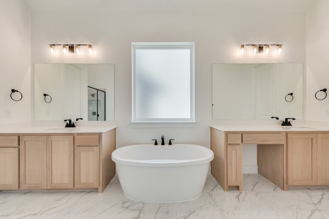 912 Shady Oaks Dr, Rockwall, TX 75087 - bathroom featuring marble look tiles, a shower stall, two vanities, and a soaking tub