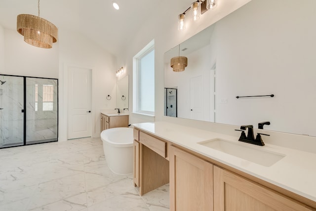 912 Shady Oaks Dr, Rockwall, TX 75087 - bathroom with a marble finish shower, marble finish flooring, two vanities, a freestanding tub, and lofted ceiling