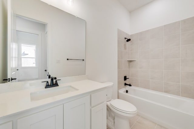 full bathroom featuring tiled shower / bath, vanity, toilet, and tile patterned floors