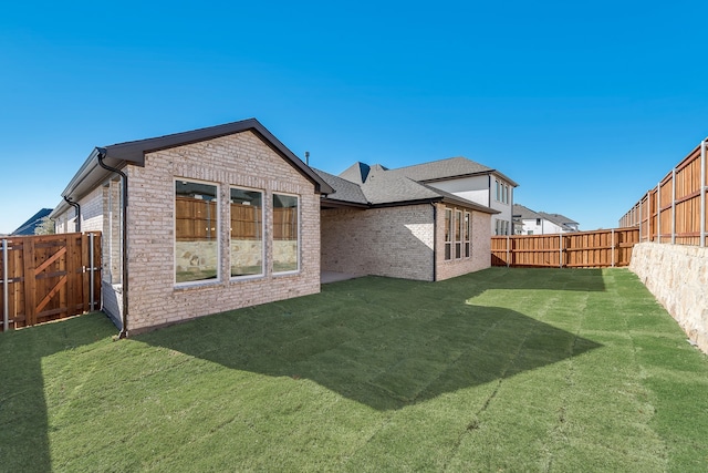 rear view of house with a lawn