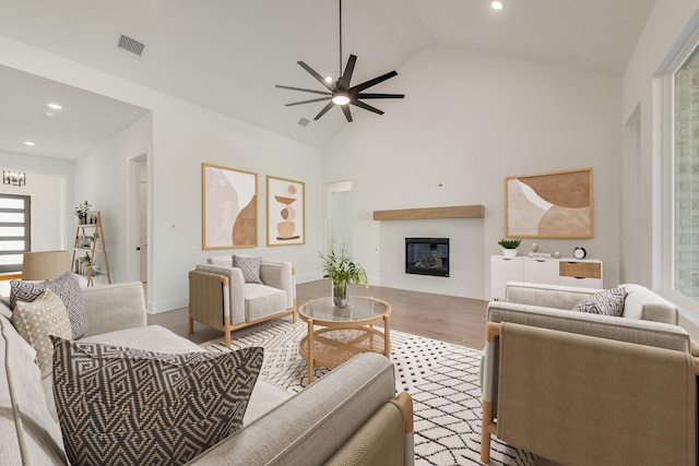 living room featuring ceiling fan, light hardwood / wood-style flooring, and high vaulted ceiling