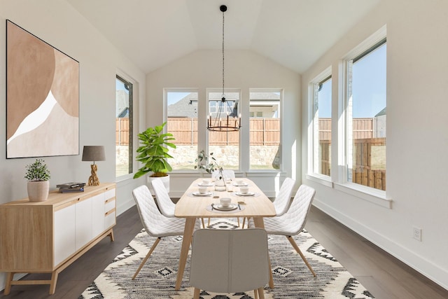 dining area with lofted ceiling, dark hardwood / wood-style flooring, plenty of natural light, and a notable chandelier